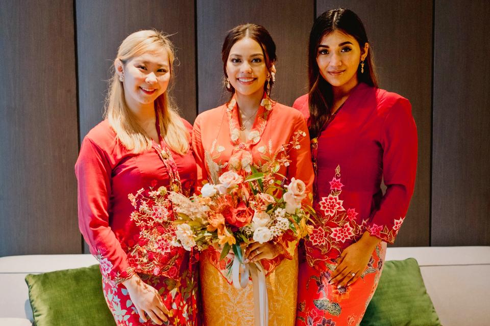 A bride and her bridesmaid wearing kebaya at a wedding. (c. 2020)