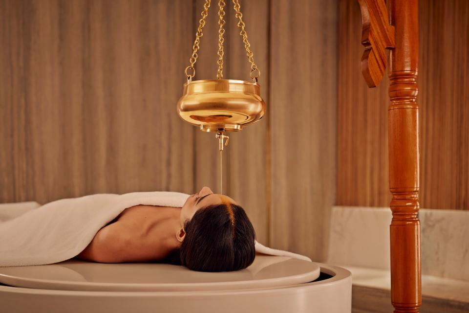 Shirodhara treatment on Vichy Shower Bed